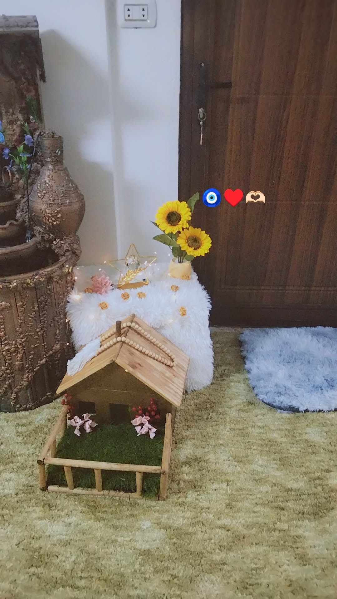 Decorative Home Setup with Miniature House and Sunflowers